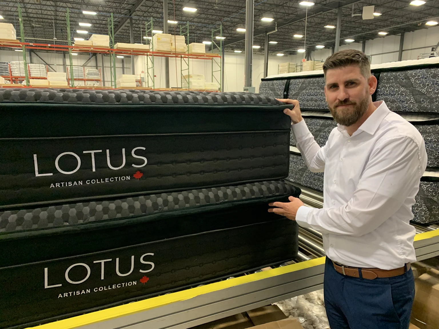 Jon, co-owner of Modern Mattress, with finished Lotus Artisan mattresses at the factory in Calgary