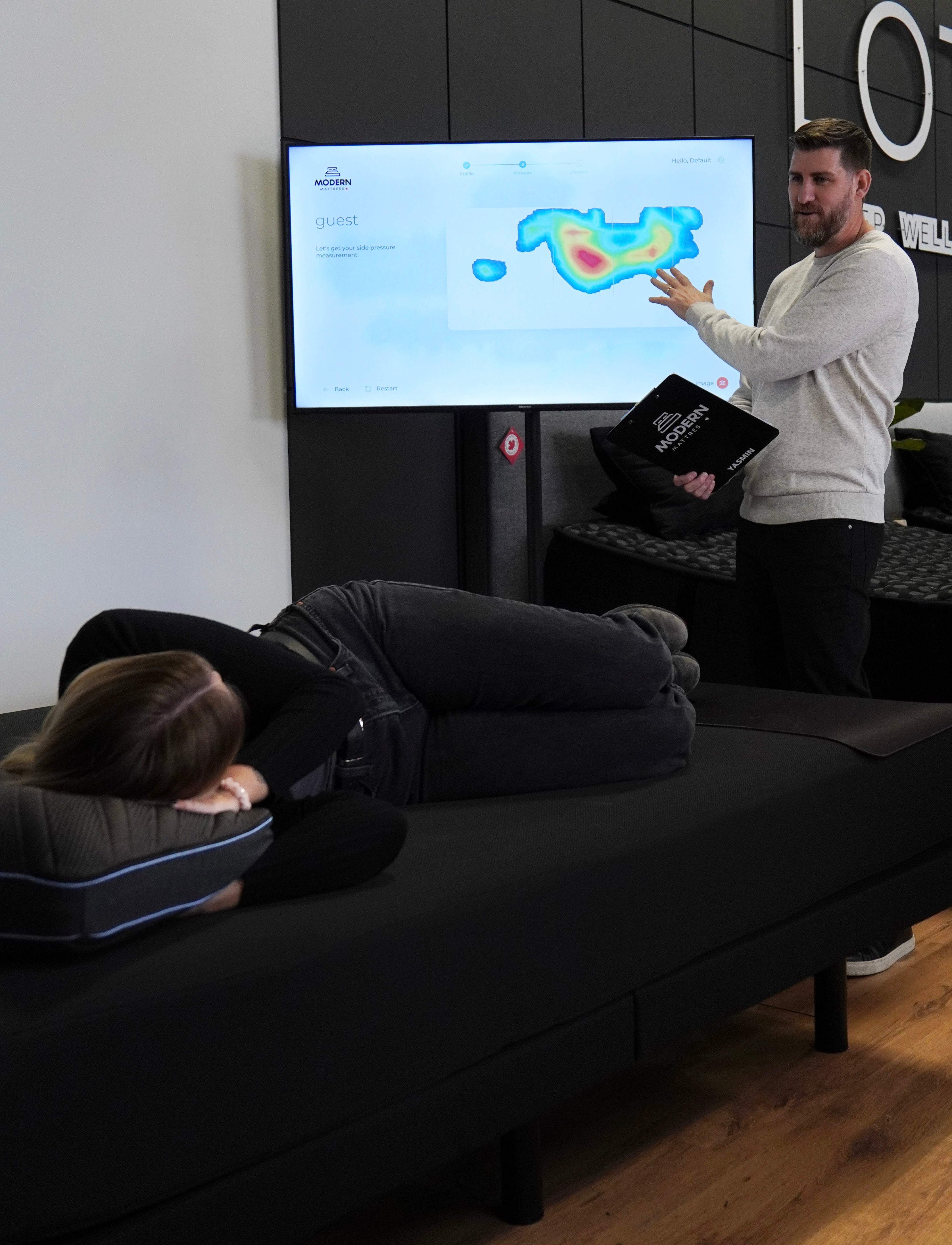 Sleep expert matching a guest to the right pillow at Modern Mattress