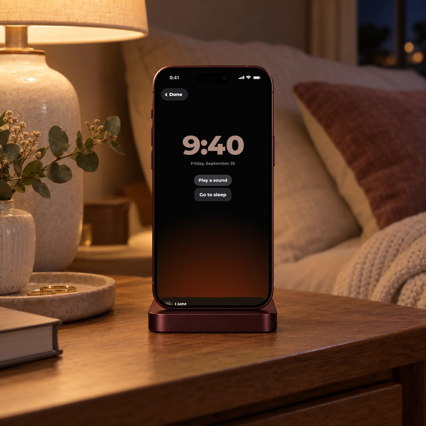 Modern Nights on a phone on a bedside table, lamp glowing softly