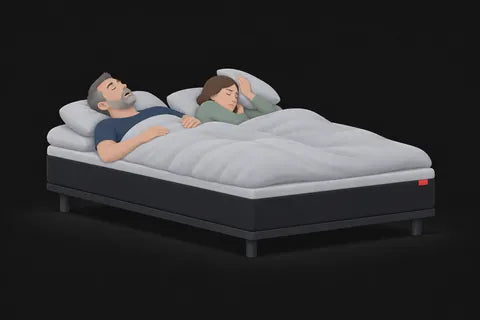A woman holding a pillow over her ear while her partner snores