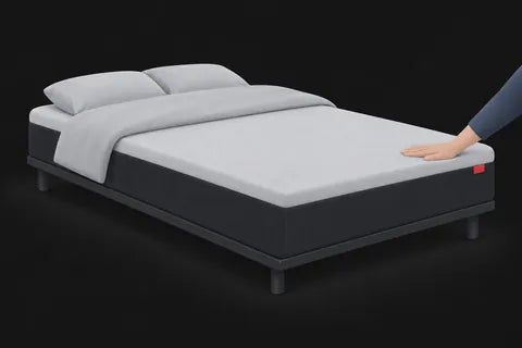 A hand pressing a firm mattress top that barely gives