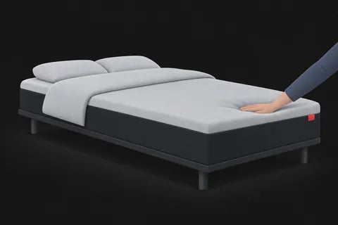 A hand sinking a little into a medium mattress top